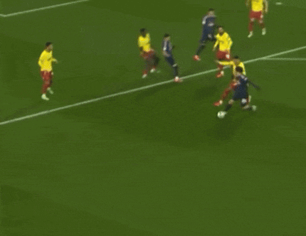 a group of soccer players are playing on a green field