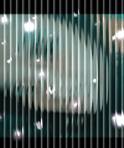a blurred image of a prison cell with a few feathers flying through it