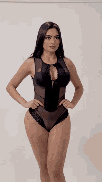 a woman in a black bodysuit with lace trim