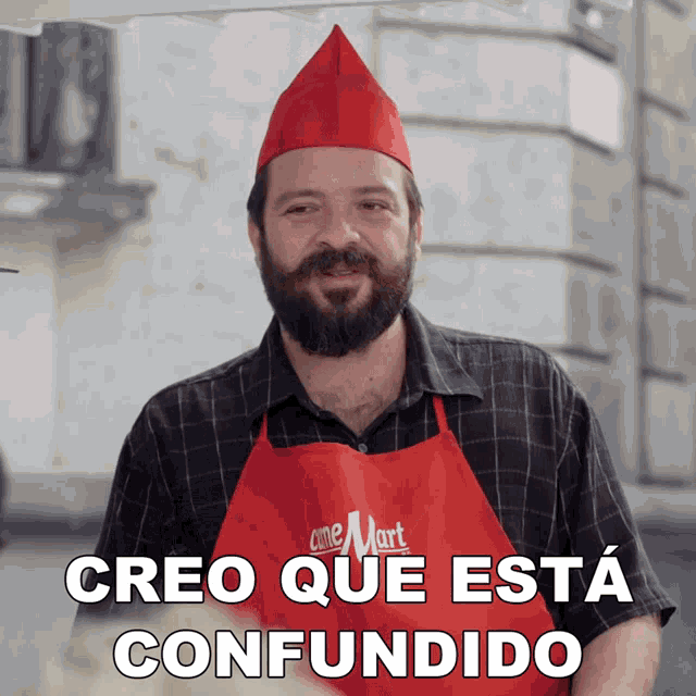 a man wearing a red apron that says cine mart