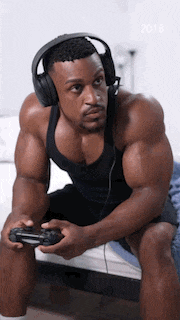 a man wearing headphones is playing a video game .