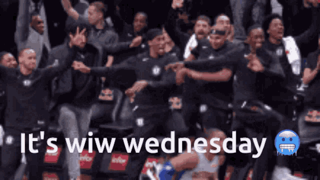 a group of people are dancing in a stadium with the words " it 's wim wednesday "