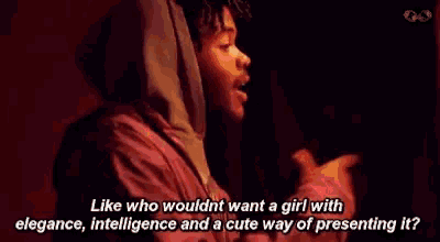 a man in a hooded jacket is talking to a woman in a red room .