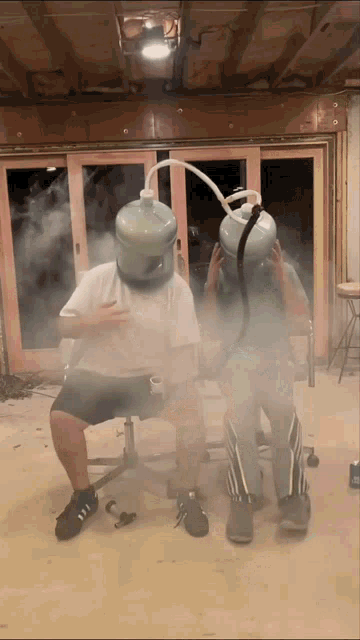 two people wearing water bottles on their heads are surrounded by smoke