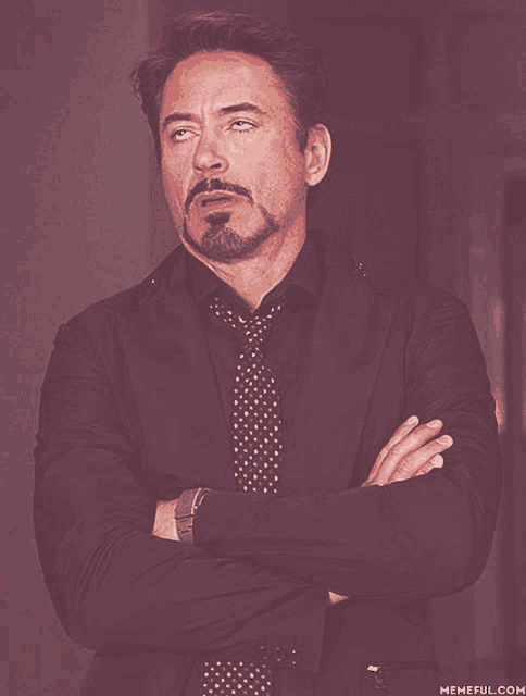 a man in a suit and tie is making a funny face with his eyes closed