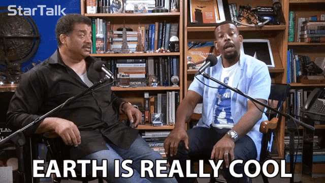 two men are sitting in front of microphones with the words earth is really cool