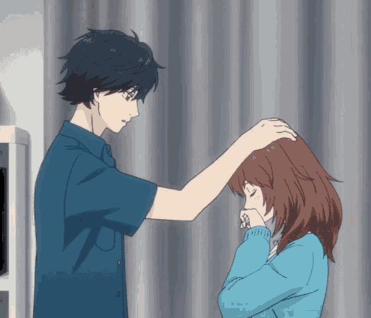 a boy and a girl are standing next to each other and the boy is touching the girl 's head