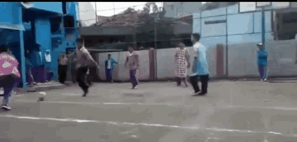 a group of people are playing a game of soccer on a court .