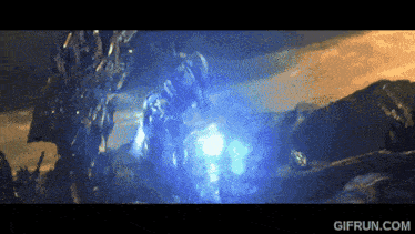 a gif from gifrun.com shows a blue light coming out of a rock