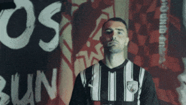 a man stands in front of a banner that says os on it