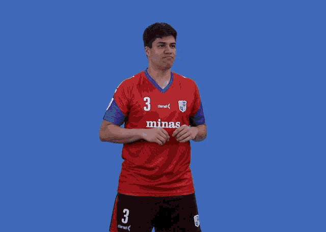 a soccer player wearing a red shirt that says minas