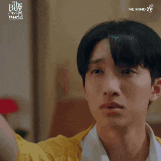 a close up of a person 's face with the words " the boy from a world " on the bottom right