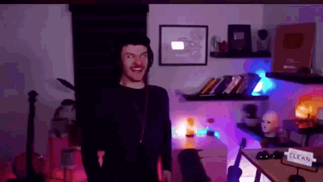 a man is standing in a room with a sign that says clean