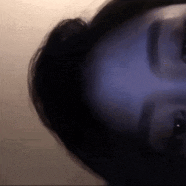 a close up of a person 's face with a blurred background .