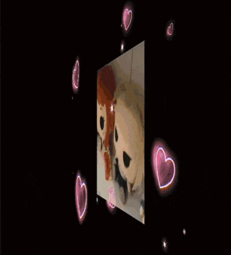 a couple of stuffed animals are surrounded by pink hearts on a black background