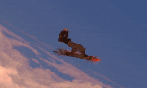 a rocket is flying through a blue sky