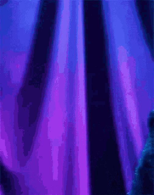a cookie monster is standing in front of a blue curtain