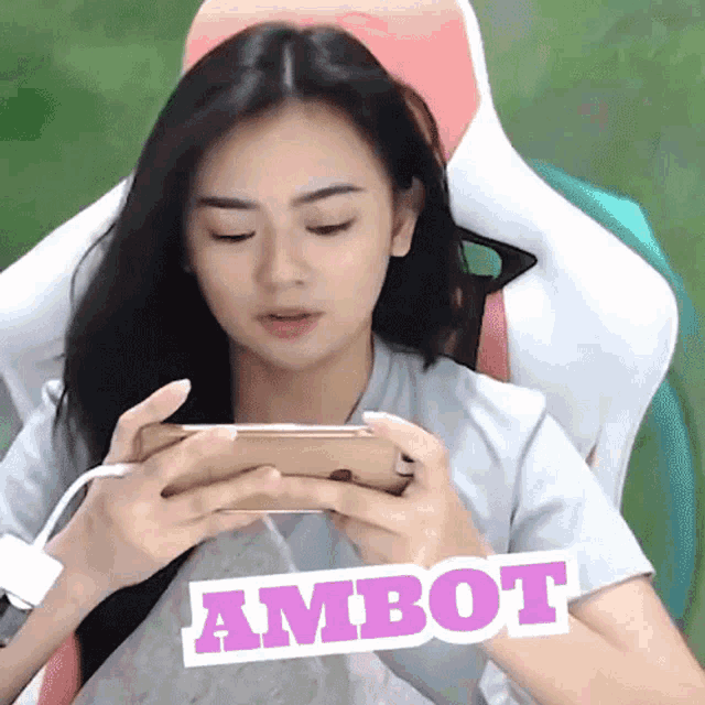 a woman playing a game with a sticker that says ambot on it