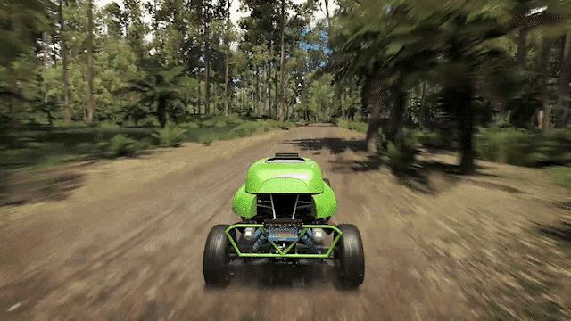 a green buggy with a california license plate is driving on a dirt road