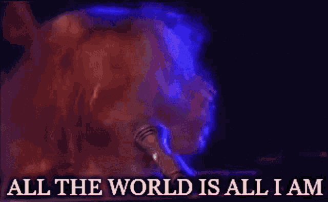 a woman singing into a microphone with the words " all the world is all i am " below her