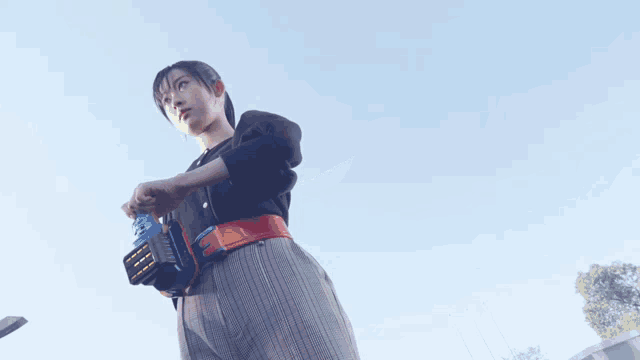 a woman is standing with her arms outstretched and the sun is shining on her waist