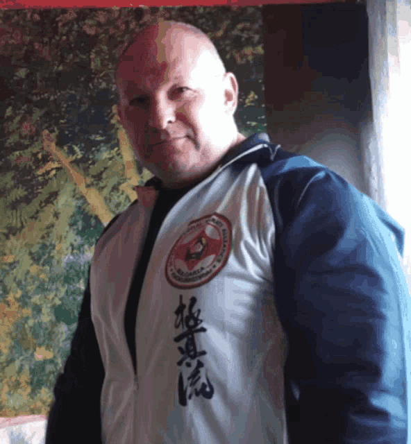 a man wearing a jacket with chinese writing on the front