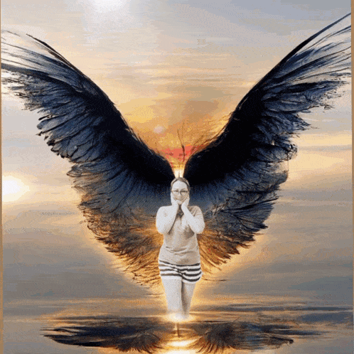 a woman is standing in the water with angel wings