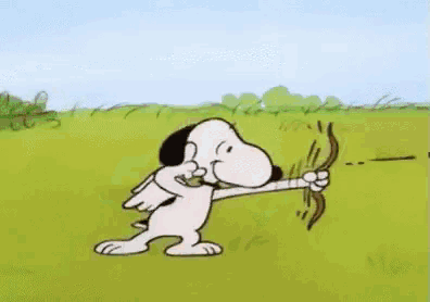 snoopy is holding a cupid bow and arrow .