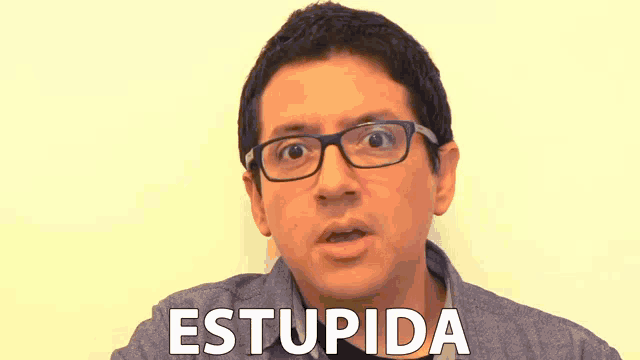 a man wearing glasses is making a funny face and the word stupida is visible in front of him
