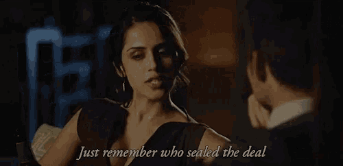 a woman holding a bottle of wine with the words just remember who sealed the deal above her