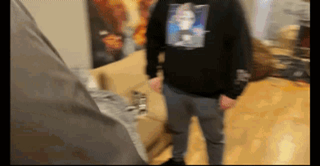 a man wearing a black shirt with a picture of a man on the back
