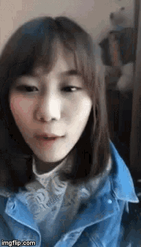 a close up of a woman wearing a blue jacket