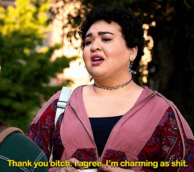 a woman in a pink jacket is saying thank you bitch i agree i 'm charming as shit