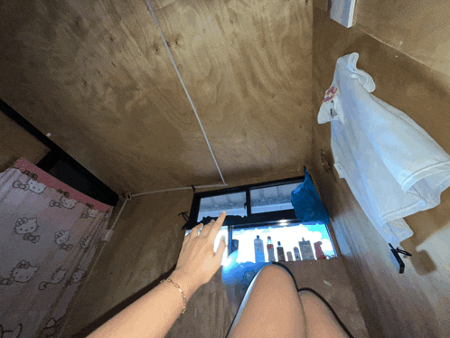a pink hello kitty shower curtain hangs on a wooden wall