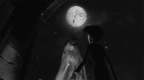 a black and white photo of a bride and groom holding hands in front of a full moon
