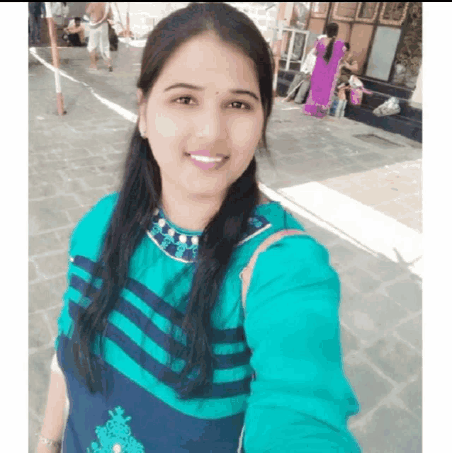 a woman is taking a selfie in front of a building