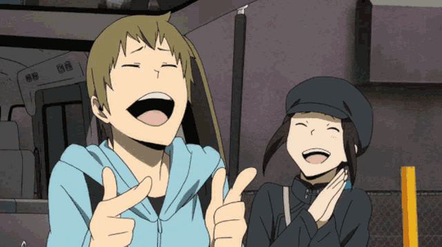 a man and a woman are laughing and giving thumbs up