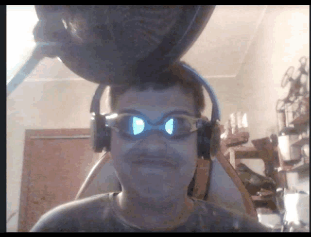a man wearing headphones and goggles has a pot on top of his head