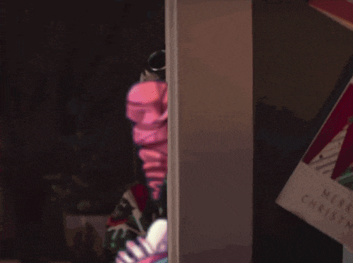 a girl with pink hair is peeking out of a doorway