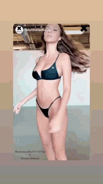a woman in a black bikini is dancing on a screen