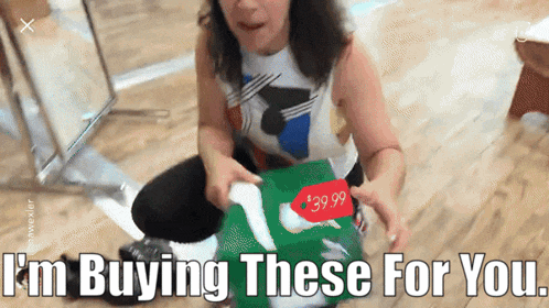 a woman is kneeling on the floor holding a green item with a price tag that says 39.99