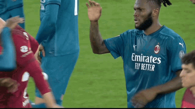 a man wearing a blue emirates fly better shirt
