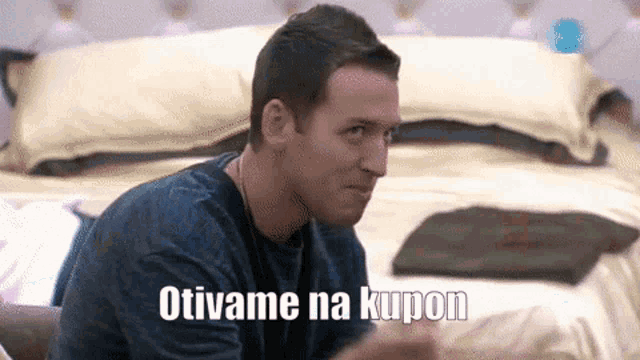a man is sitting in front of a bed with the words otivame na kupon written on the bottom