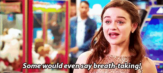 a woman in a dress is saying `` some would even say breath-taking '' in an arcade .