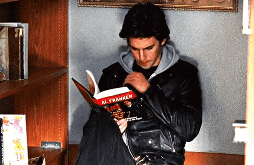 a man in a leather jacket reads a book called al franken
