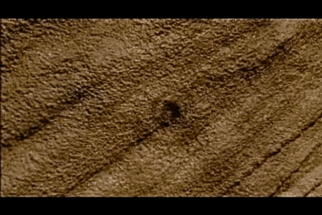 a close up of a brown surface with a hole in the middle of it