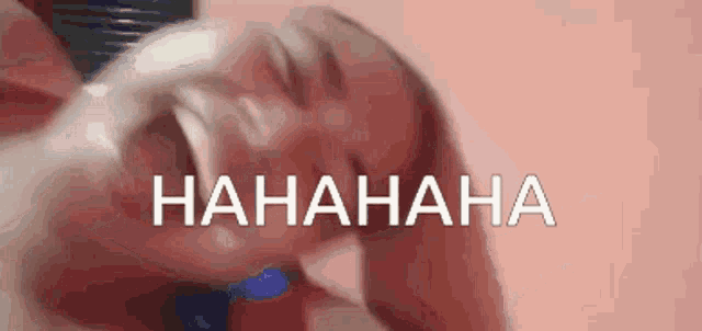 a close up of a person laughing with the word  hahaha written in white