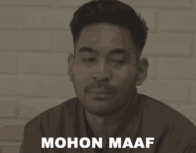 a man says mohon maaf in front of a white wall