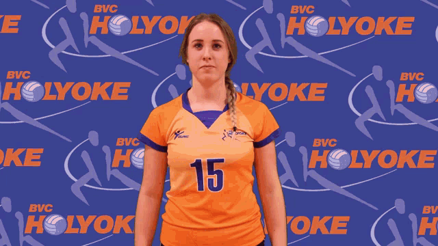 a female volleyball player with the number 15 on her shirt