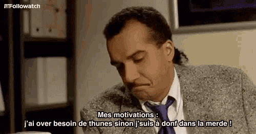 a man in a suit and tie is talking in french